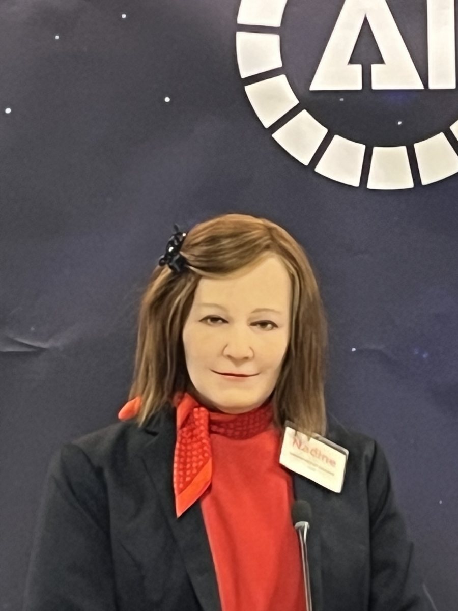 Nadine in front of the AI for Good banner